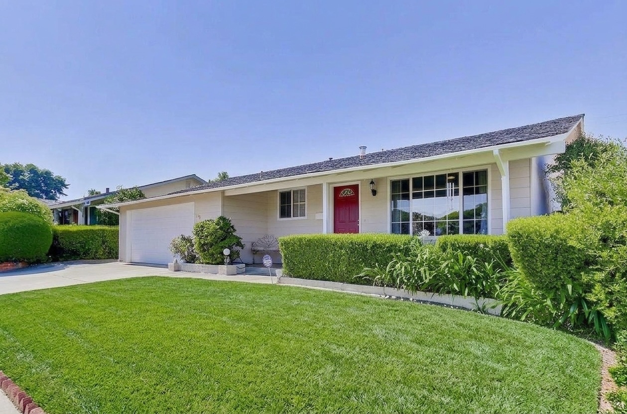 The same front yard with a green lawn